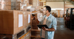 Warehouse staff tracking inventory levels with real-time scanning system